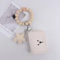 Beige silicone bead wristlet keychain with cute star charm and compact card holder wallet. - Off White