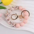 Silicone beaded keychain with floral print and solid pink beads, gold metal ring hardware. - Pink