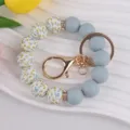 Silicone bead bracelet keychain with floral pattern and gold clasp for bags and keys. - Blue
