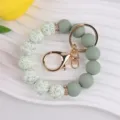 Silicone bead wristlet keychain with leaf pattern beads and gold hardware for bags. - Green