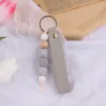 Portachiavi in pelle e silicone fatto a mano con perline di legno e crochet grigio. - Grigio chiaro