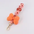 Cute macrame phone charm with daisy flowers and orange stuffed bow keychain accessories. - Orange