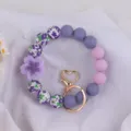 Purple silicone beaded keychain bracelet with floral pattern beads and cute heart metal clasp. - Begonia Purple