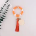 Silicone bead wristlet keychain with leather tassel and blank wooden charm for keys and bags. - Orange