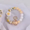 Silicone beaded keychain bracelet featuring cute floral charm and heart clasp, trendy wrist accessory. - Begonia Yellow