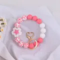 Silicone beaded keychain bracelet with flower charm, pink white wristlet accessory for women. - Begonia White