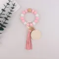 Silicone bead wristlet keychain with wooden charm, pink leather tassel and round wooden pendant. - Pink