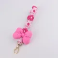 Handmade pink woven daisy bow keychain phone strap with cute bag charm accessory. - Rose Red