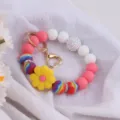 Colorful silicone bead keychain bracelet with cute daisy flower charm and heart gold metal clasp. - Daisy Yellow Pink
