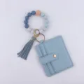 Elegante pulsera llavero de cuentas de silicona con tarjetero de cuero PU azul y borla. - Azul grisáceo