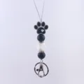 Close up detail view of silicone dog paw bead pendant charm keychain strap accessory - Black