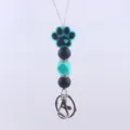 Close-up detail of the silicone dog paw bead, showing fine texture, vibrant color and metal clasp. - Lake Blue