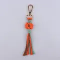Handgemachte Makramee Blumen Schlüsselanhänger bunte Baumwollkordel Taschen Deko Zubehör. - Orangerot