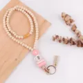 Houten kralen lanyard sleutelhanger met siliconen madeliefje boeken kwast en metalen haak. - Roze