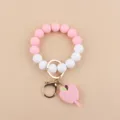 Detail view of silicone bead wristlet keychain with cute apple teacher pendant charm ring. - Light Pink Apple