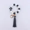 Black white silicone bead keychain wristlet with cross and leather tassel detail view. - White