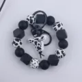 Black and white cow silicone bead keychain bracelet with cute animal pendant and metal ring. - Cartoon Cow Head Style / Black