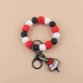 Silicone beaded keychain bracelet with cute teacher apple book pendant and metal ring detail. - Book And Apple