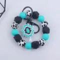 Silicone beaded wristlet keychain with cow print beads and geometric pendant for daily use. - Geometric Flower Pendant Style / Lake Blue