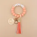 Portachiavi con bracciale di perline in silicone e ciondolo in legno cuore e nappa. - Rosa Fucsia