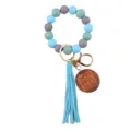 Silicone beaded wristlet keychain detail, featuring blue gray beads and wooden mama pendant. - Blue