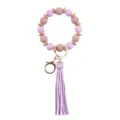 Llavero de pulsera de cuentas de silicona morada con borla de cuero PU y abalorios de madera. - Púrpura