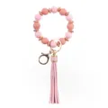 Detalle llavero cuentas silicona madera rosa con borla de PU y accesorios metal dorado. - Rosa