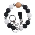 Silicone beaded wristlet keychain detail showing black white beads and leather tassel. - Black
