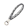 Handmade black and white woven wristlet keychain with a durable gold metal clasp ring. - Black and White