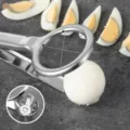 Macro detail view of a 304 stainless steel boiled egg slicer with integrated cutting wires. - Long Handle Egg Slicer