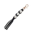 Handmade macrame keychain with black and white cotton rope, cute dog paw pattern and gold clasp. - Black and White