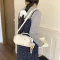 Stylish white bowling shoulder bag for women, trendy commuter crossbody handbag with cute charm. - With Charm / White
