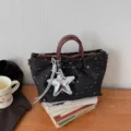 Black star print tote bag with brown handles and silver star charm, stylish casual shoulder bag. - With Charm / Black