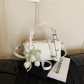 White minimalist cylindrical pillow bag, stylish crossbody shoulder bag with pearl and bow. - Beige With Pendant