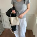 Beige woven bucket bag, stylish casual crossbody and shoulder bag variant for women style. - White