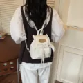Élégant mini sac à dos blanc avec bordure en dentelle, sac de voyage style collège en PU. - Avec Pendentif / Blanc Cassé