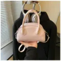 Chic pink dome handbag for women, stylish glossy shoulder and crossbody bag for modern daily wear. - No Pendant / Pink