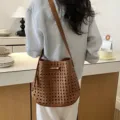 Brown woven leather bucket bag, chic hollow shoulder crossbody bag for stylish vacation wear. - Brown