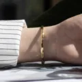 Detailed view of the elegant diamond cut titanium steel gold bracelet worn on the wrist. - 4mm Width / Gold