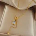 Gold stainless steel geometric crystal pendant necklace with delicate chain and drop charm. - Clear Quartz Cube Necklaces / Gold