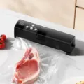 Automatic household vacuum sealer machine for dry and wet food preservation storage. - With 4 Textured Bags and 1 Zipper Bag / Black