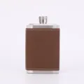 Close-up of brown leather wrapped stainless steel hip flask detail showcasing fine stitching. - Brown
