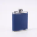 Detail view of the portable blue leather-wrapped stainless steel hip flask for outdoor camping. - 3 oz / 90 ml / Blue