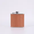 Stainless steel hip flask detail view featuring classic wood grain finish and cap. - Style 6