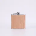 Stainless steel hip flask detail showing the wood grain wrap and cap design for outdoor use. - Style 9