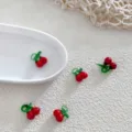Close-up of red green cherry glass beads, cute DIY jewelry making accessories for earrings. - Little Cherry