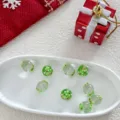 Detailed view of Christmas glass beads featuring tree pattern for DIY jewelry crafts. - 12mm Christmas Tree