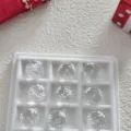 Clear glass bead detail shot featuring a white snowflake pattern inside, ideal for DIY crafts. - 15mm Snowflakes