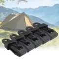Detailed view of black plastic tent clips showing the serrated clamp design and sturdy hanging hole. - Black