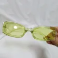 Detailed close-up shot showing stylish transparent light green sunglasses frame detail. - Green